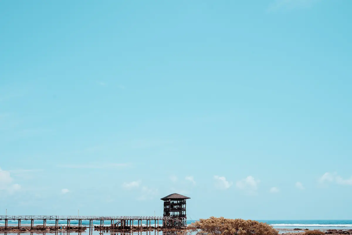 Bright blue sky over the Cloud 9 boardwalk and its viewing tower in Siargao